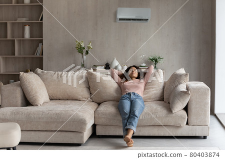 Calm young Latino woman relax breathing fresh air Calm young Latino woman relax breathing fresh air 80403874