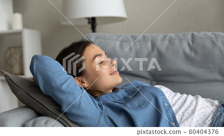 Close up beautiful young woman relaxing on couch Close up beautiful young woman relaxing on couch 80404376