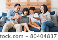 Asian family wave hands to digital tablet, online video call 80404837
