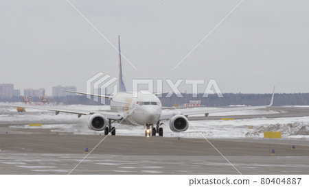 Boeing 737-800 of Mongolian Airlines taxiing on runway, winter view Boeing 737-800 of Mongolian Airlines taxiing on runway, winter view 80404887