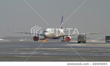 Tug towing ice covered aircraft of Aeroflot, Russia 80404893