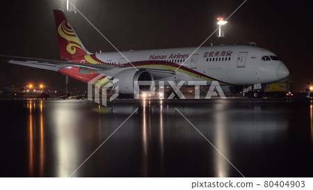 Hainan Airlines Boeing 787-8 Dreamliner parked in the airport at night Hainan Airlines Boeing 787-8 Dreamliner parked in the airport at night 80404903