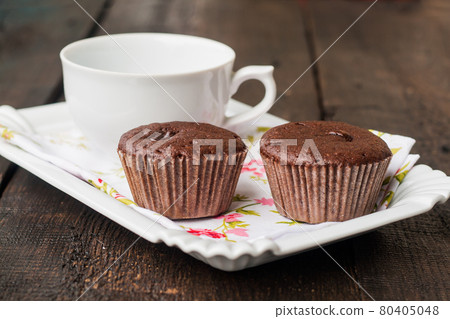 chocolate muffins, cakes and cup of coffee chocolate muffins, cakes and cup of coffee 80405048