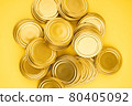 Lids for jars of gold color top view on a yellow background. 80405092