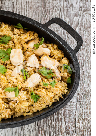 Pilaf rice-curry with chicken and salad in the form of iron Pilaf rice-curry with chicken and salad in the form of iron 80405135