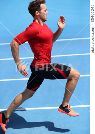 Runner sprinting towards success on run path running athletic track. Goal achievement concept. Male athlete sprinter doing a fast sprint for competition on blue lanes. Track running. 80405243