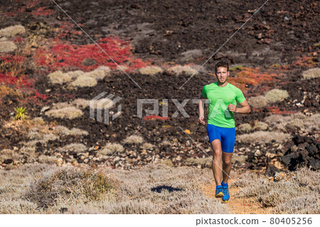 Sport athlete runner man running in mountain trail nature background. Focused motivated fit person training body jogging in rocky terrain summer outdoors. Sport athlete runner man running in mountain trail nature background. Focused motivated fit person training body jogging in rocky terrain summer outdoors. 80405256