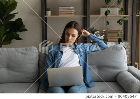 Woman put wireless computer on laps do shopping from home Woman put wireless computer on laps do shopping from home 80405647