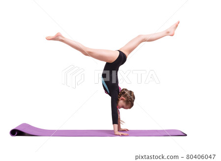 Cute child girl making Gymnastic exercises against white. 80406047