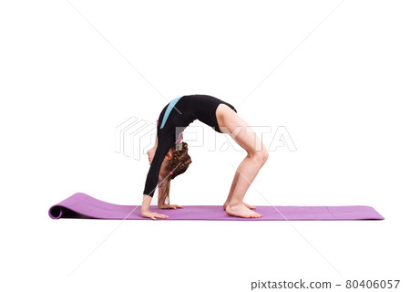 Cute child girl making Gymnastic exercises against white background. 80406057