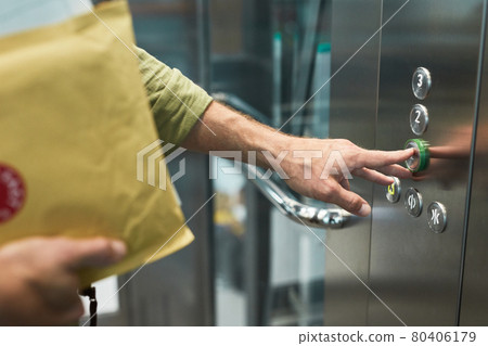 Delivery Guy in Elevator Close Up Delivery Guy in Elevator Close Up 80406179