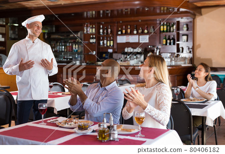 Restaurant guests applaud and thank restaurant chef Restaurant guests applaud and thank restaurant chef 80406182