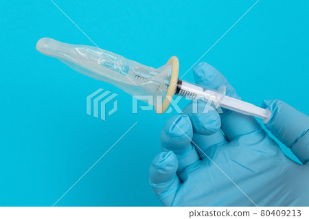 Anti Vaccination Concept - Syringe in a Condom Anti Vaccination Concept - Syringe in a Condom 80409213