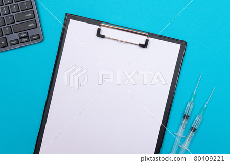 Vaccination or Revaccination Concept - Two Medical Syringe on Blue Table Vaccination or Revaccination Concept - Two Medical Syringe on Blue Table 80409221