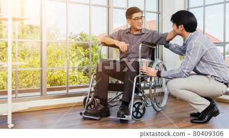 old man in a wheelchair and his young son old man in a wheelchair and his young son 80409306