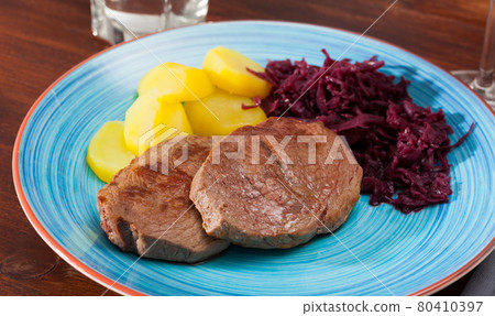 Veal steak with potato and sauerkraut Veal steak with potato and sauerkraut 80410397