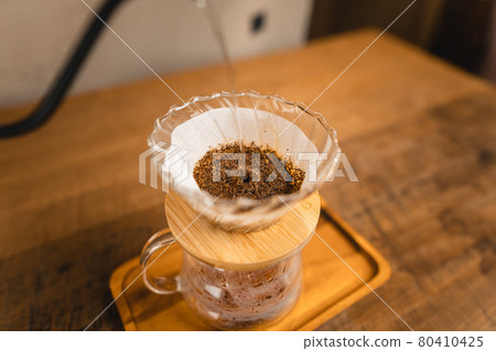 Pouring a hot water over a drip coffee Pouring a hot water over a drip coffee 80410425