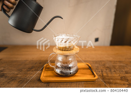 Pouring a hot water over a drip coffee 80410440