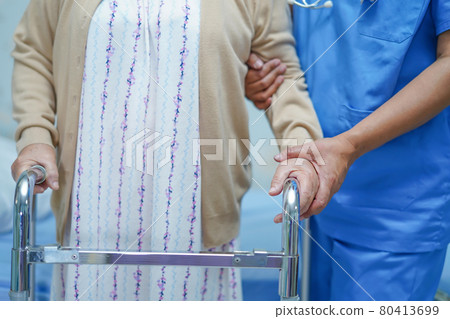 Asian nurse physiotherapist doctor care, help and support senior or elderly old lady woman patient walk with walker at hospital ward : healthy strong medical concept.. 80413699