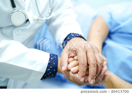 Holding Touching hands Asian senior or elderly old lady woman patient with love, care, helping, encourage and empathy at nursing hospital ward : healthy strong medical concept . 80413700