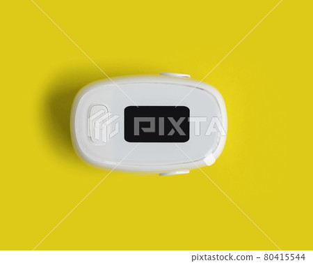Pulse oximeter or blood oxygen level measure monitor device isolated on yellow background. Diagnosis self check up. Medical and healthcare equipment. Coronavirus covid-19 outbreak. 80415544