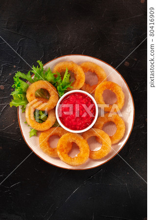 Calamari rings. Squids with lettuce and tomato sauce, shot from above Calamari rings. Squids with lettuce and tomato sauce, shot from above 80416909