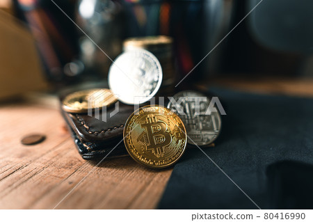 Bitcoin coins on a wooden desk Bitcoin coins on a wooden desk 80416990