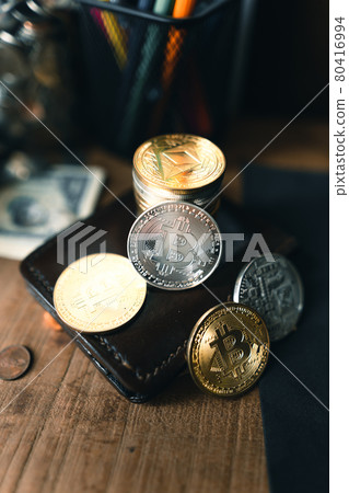 Bitcoin coins on a wooden desk Bitcoin coins on a wooden desk 80416994