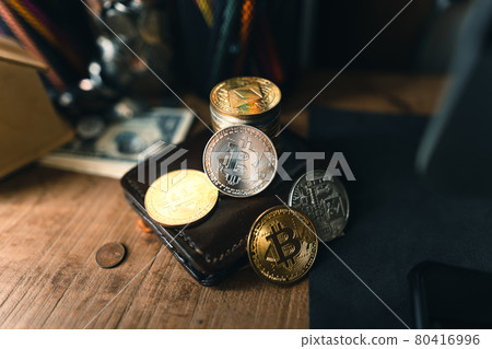 Bitcoin coins on a wooden desk Bitcoin coins on a wooden desk 80416996