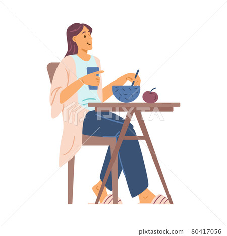 Happy young woman eat breakfast, lunch or dinner sitting at table in home kitchen 80417056