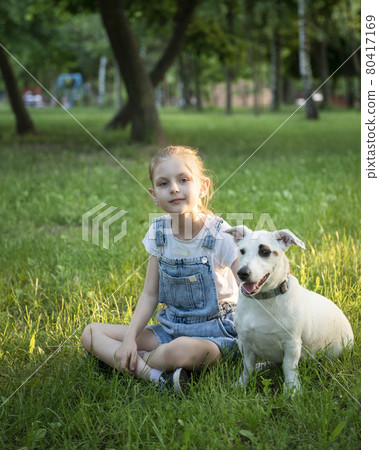 Little girl playing with a dog Little girl playing with a dog 80417169