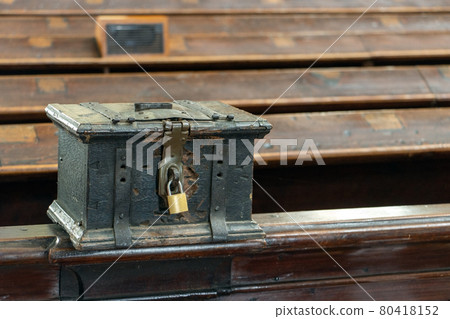 The church money box mounted on a pew in the church 80418152