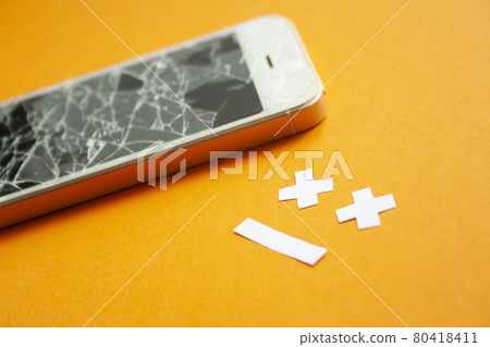 Broken smartphone with cracked destroyed screen 80418411
