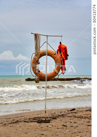 Rescue equipment on the water, lifebuoy and life jacket on the beach 80418774
