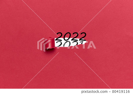 Number 2022 coming out of a torn red cardboard. Concept New Year 80419116