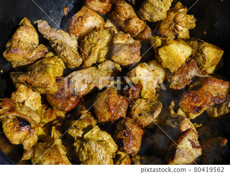 The meat is fried in a cast iron pot The meat is fried in a cast iron pot 80419562