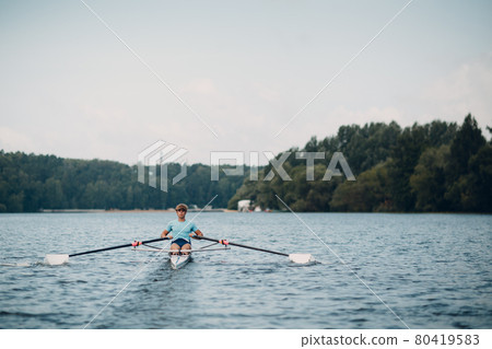 Sportsman single scull man rower prepare to competition boat regatta. Olympic games sport. Sportsman single scull man rower prepare to competition boat regatta. Olympic games sport. 80419583