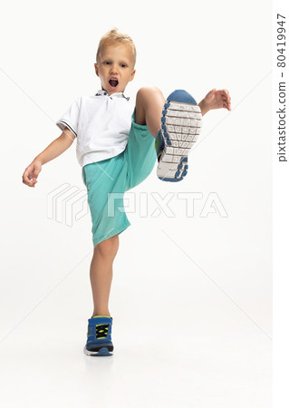 Portrait of cute preschool boy in shirt and shorts isolated on white studio background. Copyspace for ad. Childhood, education, emotion concept 80419947