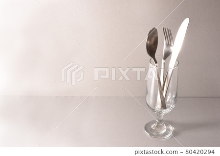 Spoon, knife and fork in a glass Spoon, knife and fork in a glass 80420294