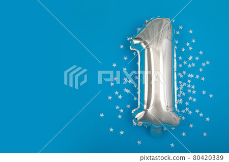 Silver balloon 1 on a blue background with confetti stars 80420389