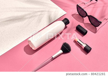 Woman's accessories lying flat on textured paper background. Pink and white pastel colors with copy space around products. Woman's accessories lying flat on textured paper background. Pink and white pastel colors with copy space around products. 80421281