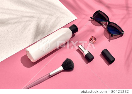 Woman's accessories lying flat on textured paper background. Pink and white pastel colors with copy space around products. Woman's accessories lying flat on textured paper background. Pink and white pastel colors with copy space around products. 80421282