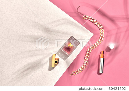 Fashionable Women's Cosmetics and Accessories. Flat Lay. Perfume. Pink and white background. Shadow from a palm leaf Fashionable Women's Cosmetics and Accessories. Flat Lay. Perfume. Pink and white background. Shadow from a palm leaf 80421302