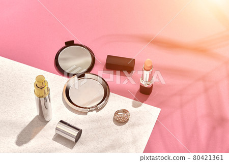 Fashionable Women's Cosmetics and Accessories. Flat Lay. Pink and white background. Shadow from a palm leaf. Sun flare Fashionable Women's Cosmetics and Accessories. Flat Lay. Pink and white background. Shadow from a palm leaf. Sun flare 80421361