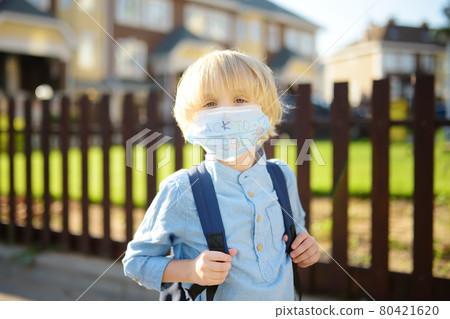 Child in face mask going at reopen school after covid-19 quarantine and lockdown. It is new normal for protection and prevention while outbreak of coronavirus or flu. 80421620