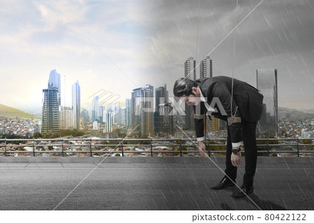 Asian businessman controlled with rope with different climates 80422122