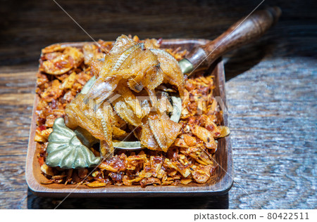Dried chilli paste with crispy fish thai style or Crispy fish chilli paste on wooden bowl. Dried chilli paste with crispy fish thai style or Crispy fish chilli paste on wooden bowl. 80422511