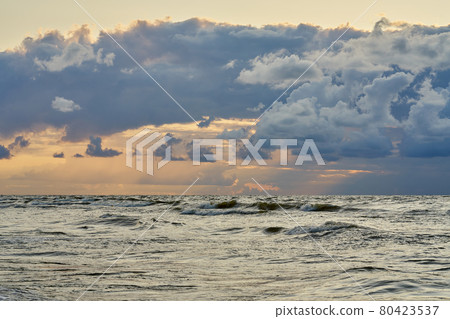 Epic dark sunset sky above the sea shore after the storm. Epic dark sunset sky above the sea shore after the storm. 80423537