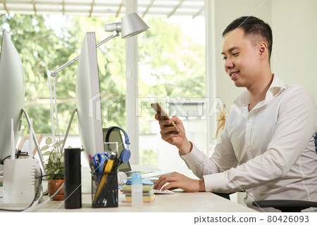 Businessman Answering Text Messages 80426093