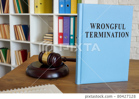 Rules about wrongful termination and employment on the desk. Rules about wrongful termination and employment on the desk. 80427128